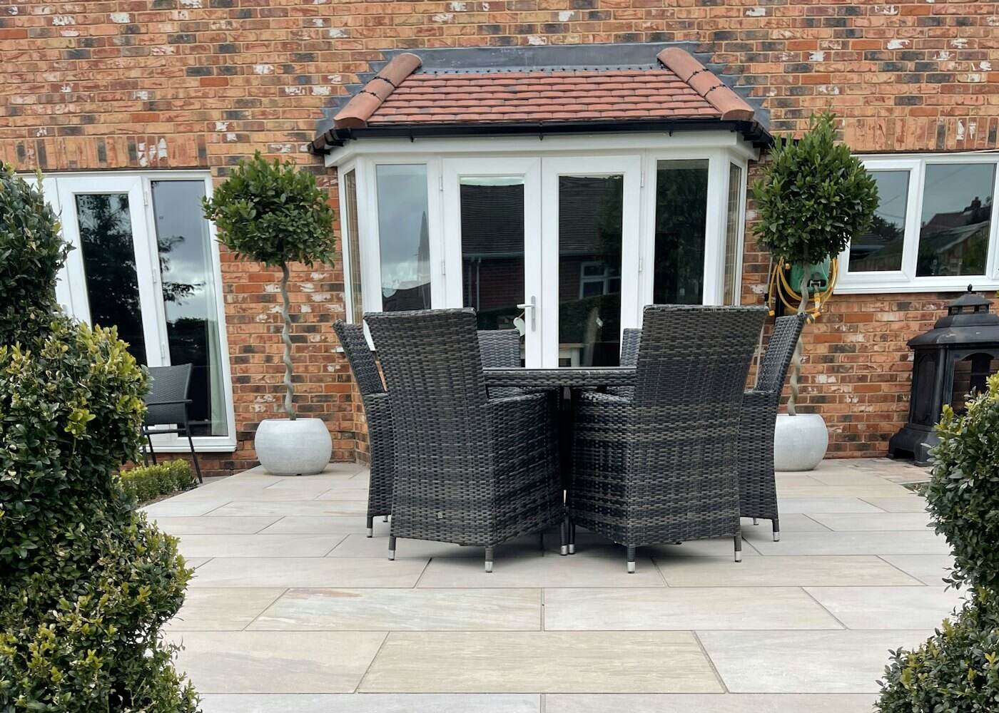 A brick terrace and garden at the rear of a Cheshire house